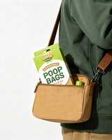 Person carrying unscented dog waste bags against a white background.